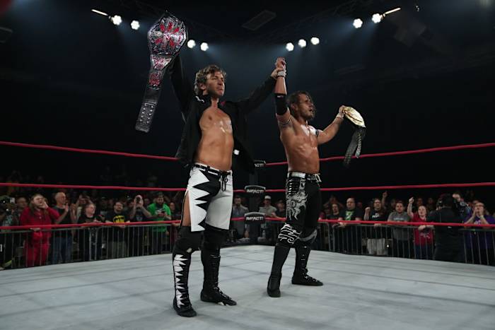 The Motor City Machine Guns celebrate in the ring